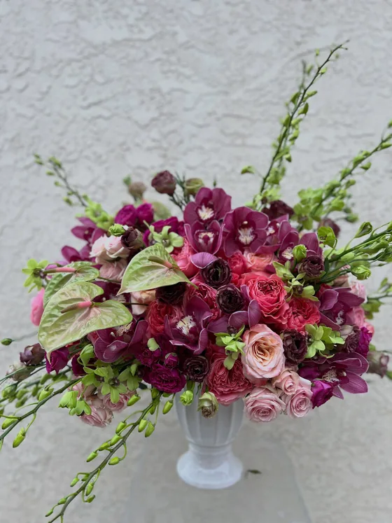 Custom magenta orchid, anthurium and rose arrangement in a white vase